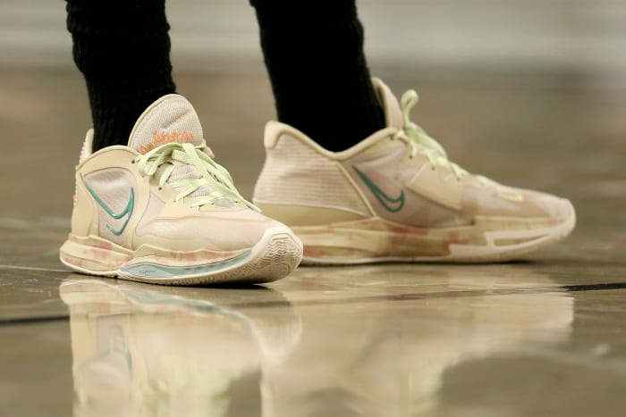 View of Kyrie Irving's tan Nike shoes.
